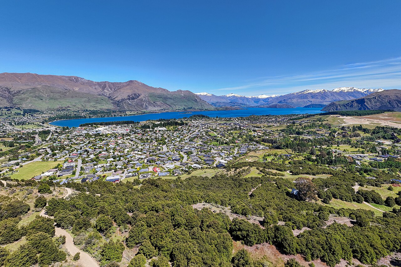 Scenic view over Lake Wanaka with deep blue water and surrounding alpine mountain ridges
